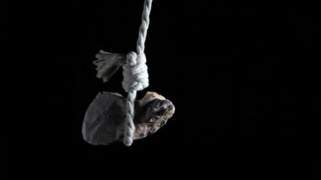The stone sways tied to a rope