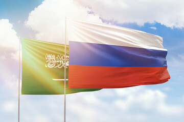 Sunny blue sky and flags of russia and saudi arabia