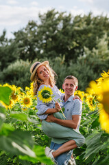 Couple in love on the background of a field with sunflowers