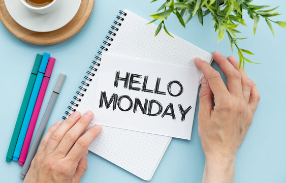 Hello monday, Blank album paper with hello monday inscription on table with office items