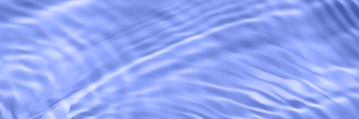 The surface of light on the purple transparent swimming pool water. Abstract wavy background. Water waves in sunlight banner. Square Trendy long banner with 2022 color of the year very peri.