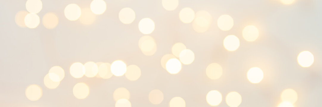 Background with abstract golden sparkling christmas lights. Bokeh effect. Defocused. Template for holiday card. Banner