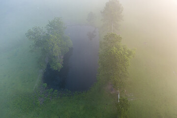 Aerial view of a pond in the dense fog.