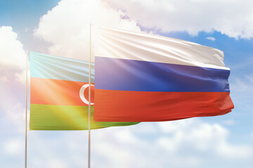 Sunny blue sky and flags of russia and azerbaijan