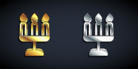Gold and silver Candelabrum with three candlesticks icon isolated on black background. Long shadow style. Vector