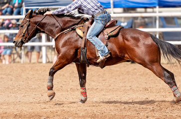 Cowboy Competing In Barrel Race At Country Rodeo