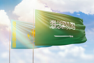 Sunny blue sky and flags of saudi arabia and kazakhstan