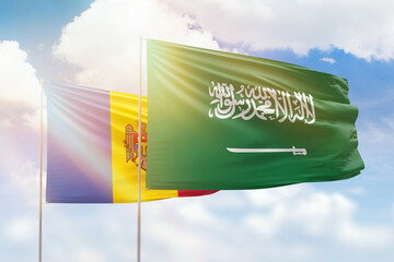 Sunny blue sky and flags of saudi arabia and moldova