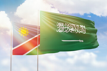 Sunny blue sky and flags of saudi arabia and namibia