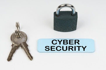 On a white surface there is a lock, keys and a blue sign with the inscription - Cyber security