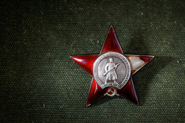 Red Star order on green background, Russia. Old Russian military medal