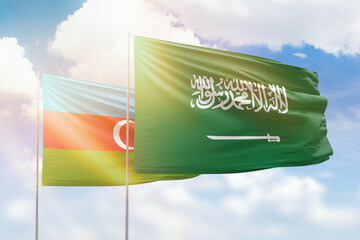 Sunny blue sky and flags of saudi arabia and azerbaijan