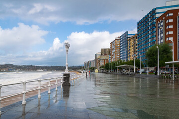 Empty promenade on Playa de San Lorenzo after rain in Gijon, Asturias, Spain.