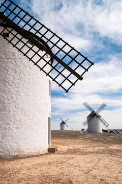 Old white windmills against a blue sky in Campo de Criptana, Castile la Mancha, Spain.