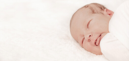 Newborn baby in crib on white blanket, baby portrait 7 days old. The first days of life