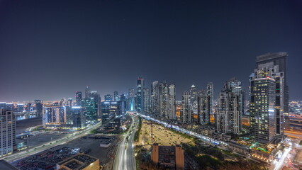 Bay Avenue with modern towers residential development in Business Bay aerial panoramic night timelapse, Dubai