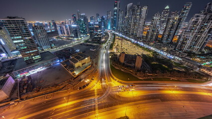 Obraz na płótnie Canvas Bay Avenue with modern towers residential development in Business Bay aerial panoramic night timelapse, Dubai