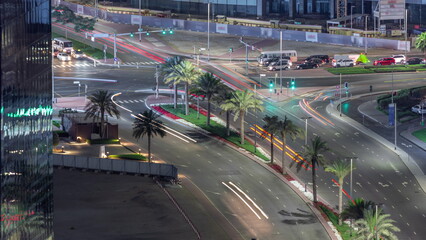 Aerial top view of city traffic on a crossroad in Dubai Business bay night timelapse.