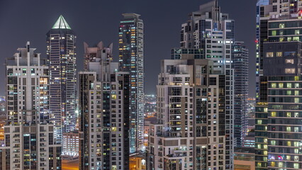 Fototapeta na wymiar Bay Avenue with modern towers residential development in Business Bay aerial night timelapse, Dubai