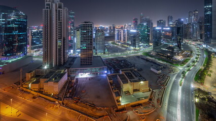 Fototapeta na wymiar Business Bay Dubai skyscrapers with water canal aerial all night timelapse.