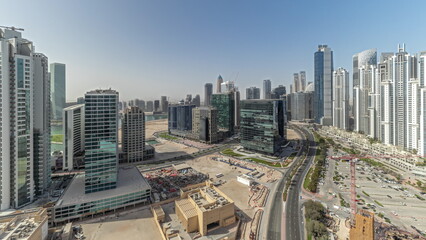 Naklejka na ściany i meble Panorama showing Bay Avenue with modern towers residential development in Business Bay aerial timelapse, Dubai