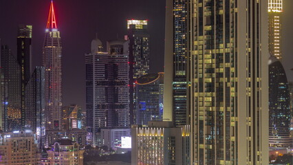Row of the tall buildings around Sheikh Zayed Road and DIFC district aerial night timelapse in Dubai