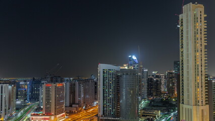Fototapeta na wymiar Skyscrapers at the Business Bay in Dubai aerial night timelapse, United Arab Emirates