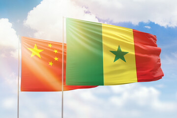 Sunny blue sky and flags of senegal and china