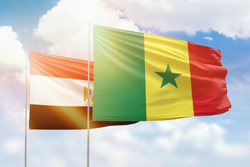 Sunny blue sky and flags of senegal and egypt