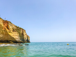 Fototapeta na wymiar coast of portugal in carvoeiro faro albufeira.beautiful view of bright rocks and green shores of atlantic ocean coast in portugal 