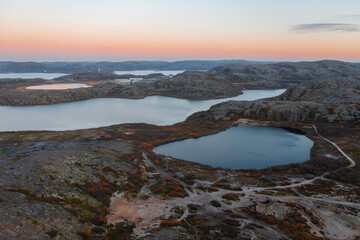 Lake in Teriberka in autumn. Colorful tundra landscape on the Kola Peninsula in autumn