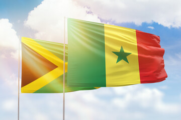 Sunny blue sky and flags of senegal and jamaica