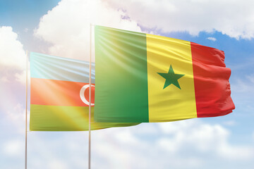 Sunny blue sky and flags of senegal and azerbaijan