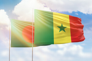 Sunny blue sky and flags of senegal and bangladesh