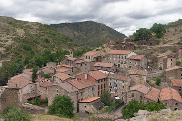 Fototapeta na wymiar Village called Viniegra de Arriba surrounded by mountains with cloudy sky, Spain.