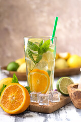 glas with lemonade or mojito cocktail with lemon and mint, cold refreshing drink or beverage with ice