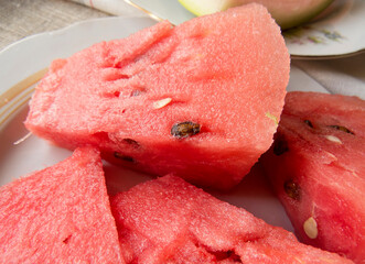 Fresh sliced watermelon close-up  Beautiful  organic eco wegan  photo food background  Slices of juicy and tasty watermelon on a white plate.