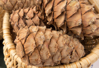 Pine cones in a wooden basket close-up. Organic food, eco food farm shop. Skins, nuts - autumn agricultural background photo