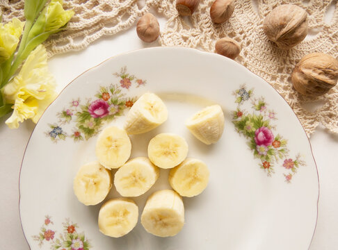 Banana bunch and peeled pieces  photo Banana and nuts Tropical fruits, banana snack or vegetarian nutrition.  Top view
