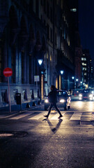 cinematic scene person walking crossing the street at night Buenos Aires, Argentina