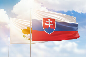 Sunny blue sky and flags of slovakia and cyprus