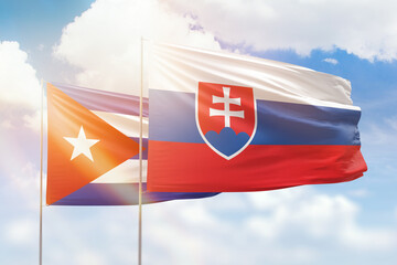 Sunny blue sky and flags of slovakia and cuba