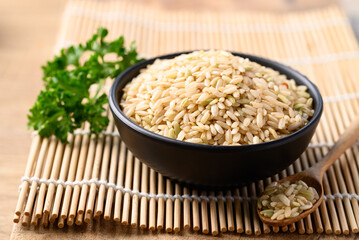Organic Thai brown rice grain in bowl, Healthy food ingredients