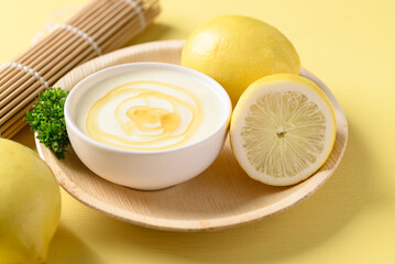 Lemon yogurt with honey in bowl on yellow, Healthy eating and beauty skincare