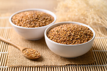 Golden flax seed or linseed in bowl with spoon