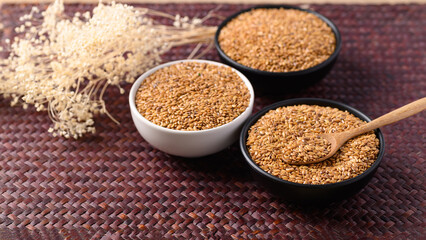 Golden flax seed or linseed in bowl with spoon