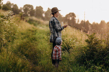 Summer trip with children to the mountains. Evening walk of a mother with a child in an alpine village in summer.