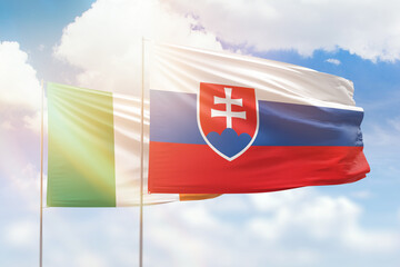 Sunny blue sky and flags of slovakia and ireland