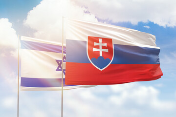 Sunny blue sky and flags of slovakia and israel