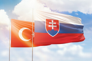 Sunny blue sky and flags of slovakia and turkey
